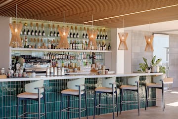 a bar with a counter and chairs