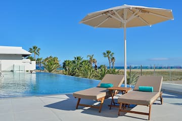 a pool with a deck chair and umbrella