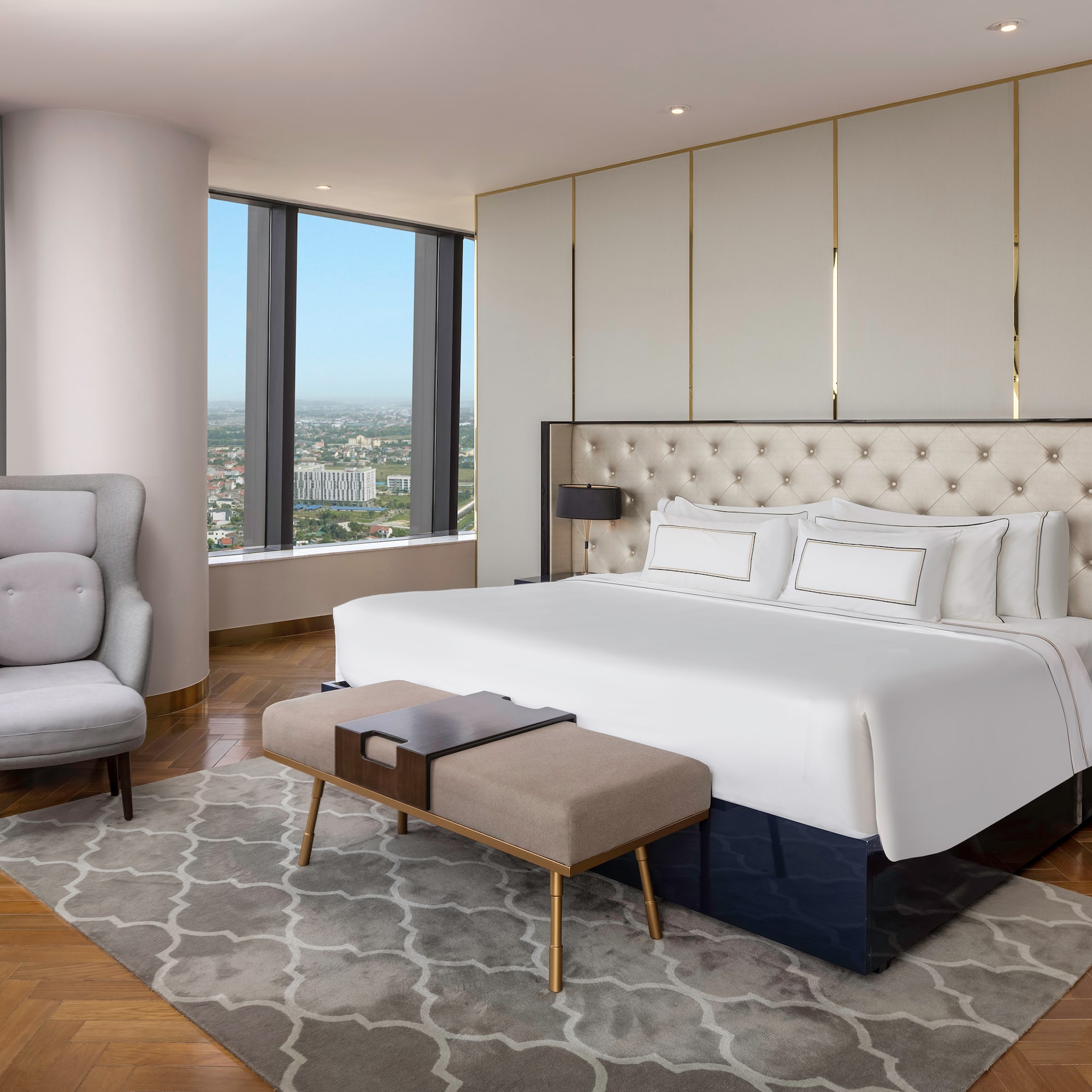 a bedroom with a large bed and a chair