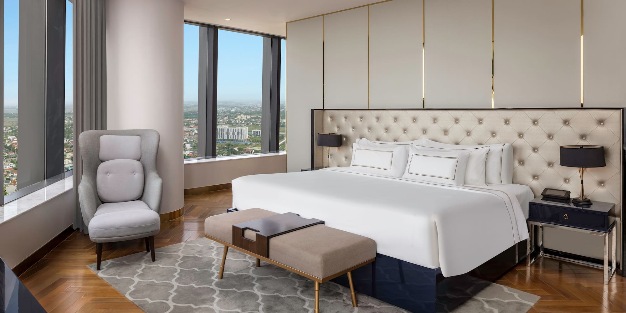 a bedroom with a large bed and a chair