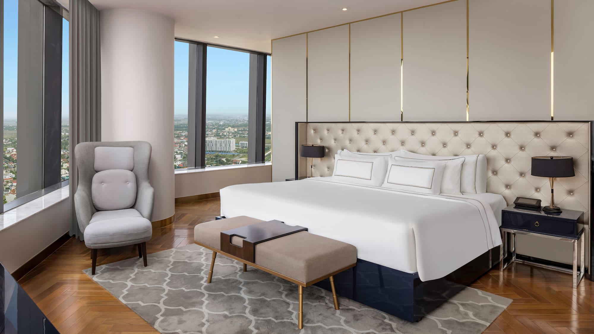 a bedroom with a large bed and a chair