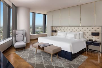 a bedroom with a large bed and a chair