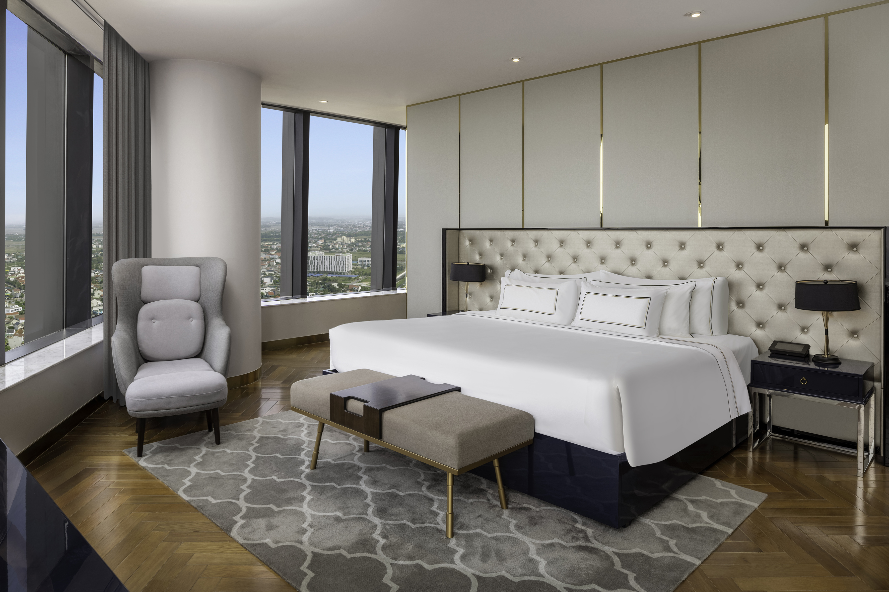 a bedroom with a large bed and a chair