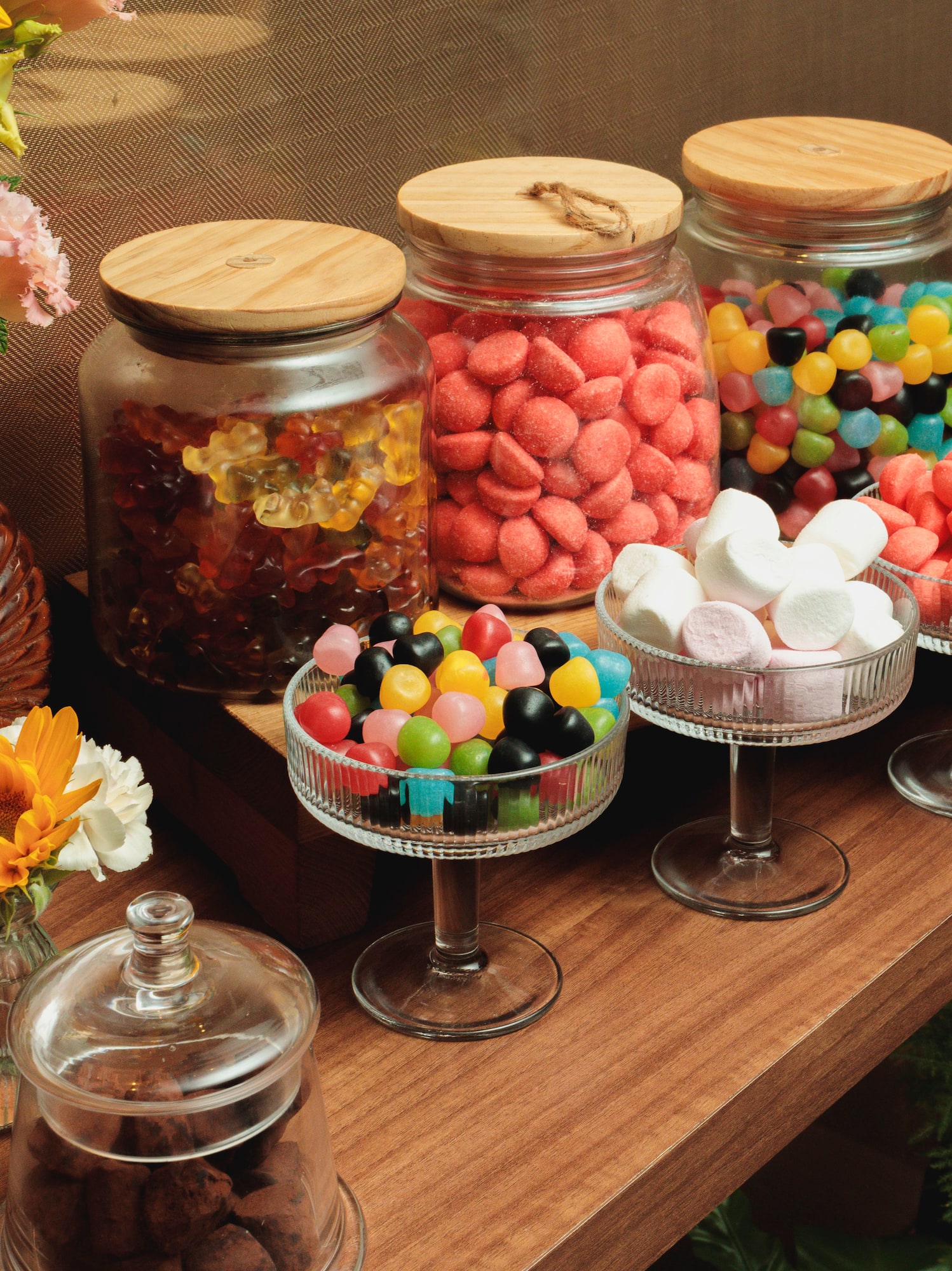 Candy bar with assorted sweets, marshmallows, gummy bears, and a strawberry tart.