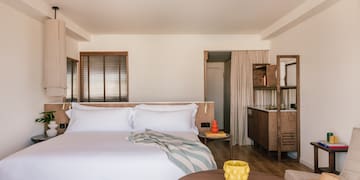 a bedroom with a bed and a table