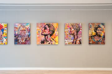 a group of paintings on a wall