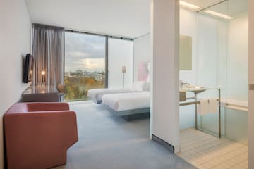 a room with two beds and a desk