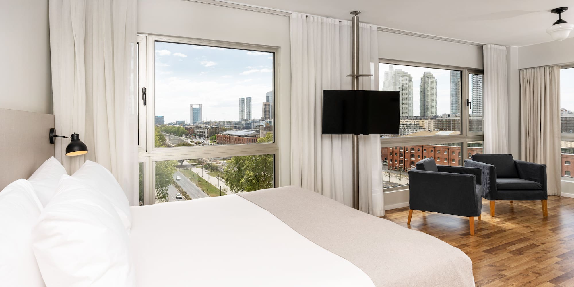 a bedroom with a large window and a large bed