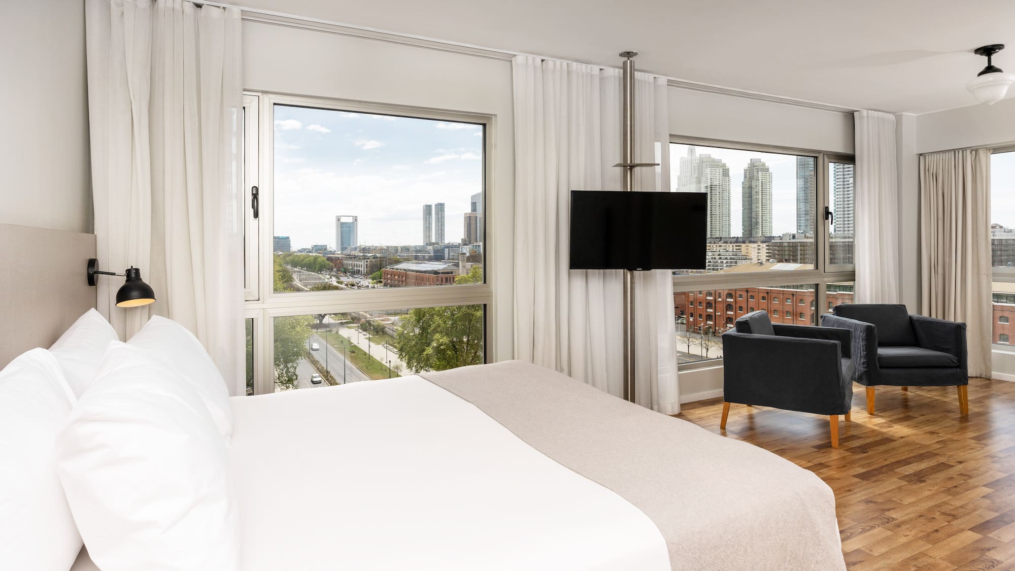 a bedroom with a large window and a large bed
