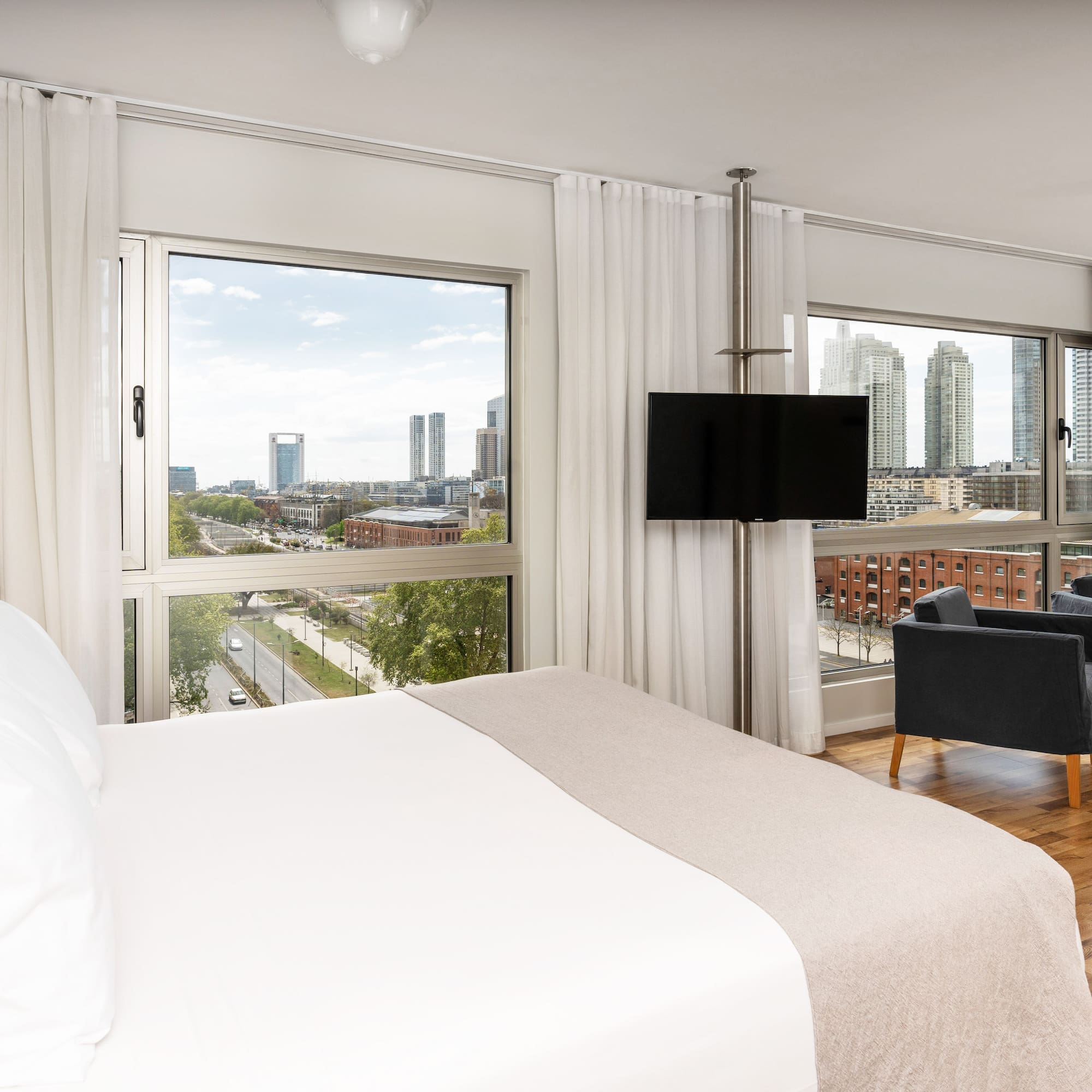 a bedroom with a large window and a large bed