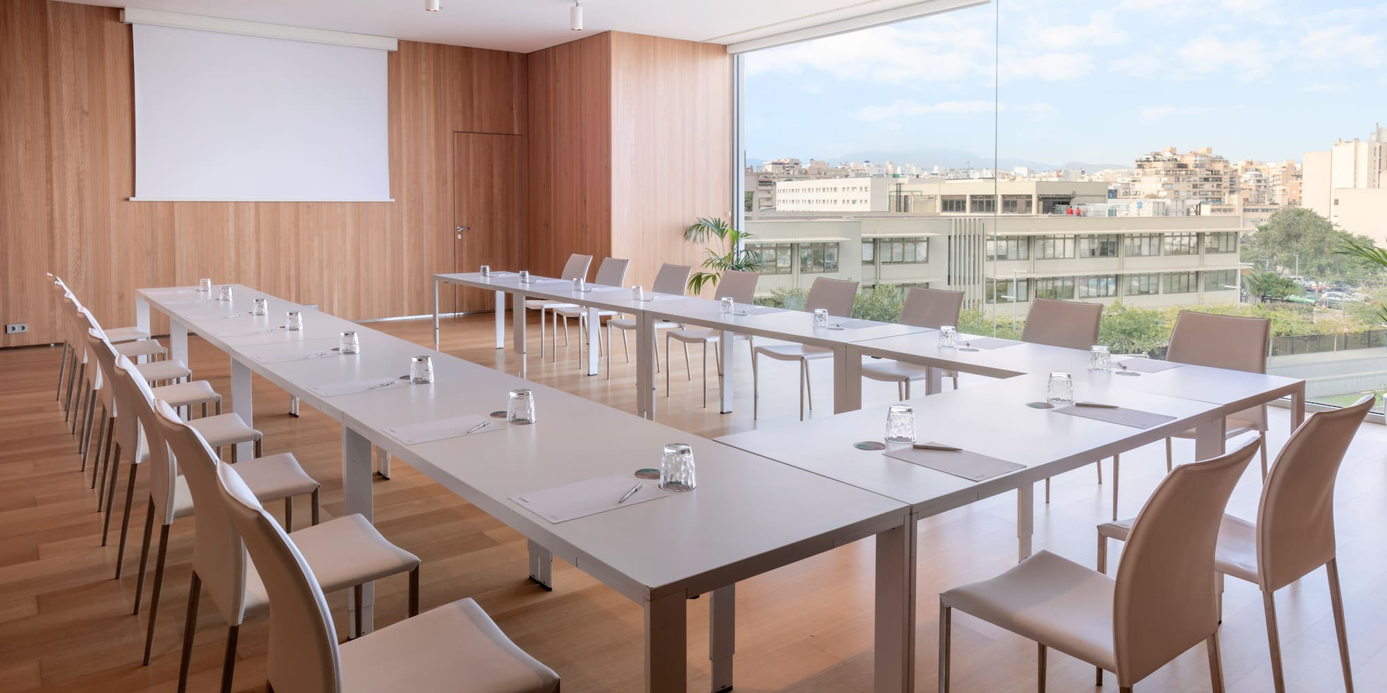 a room with white tables and chairs