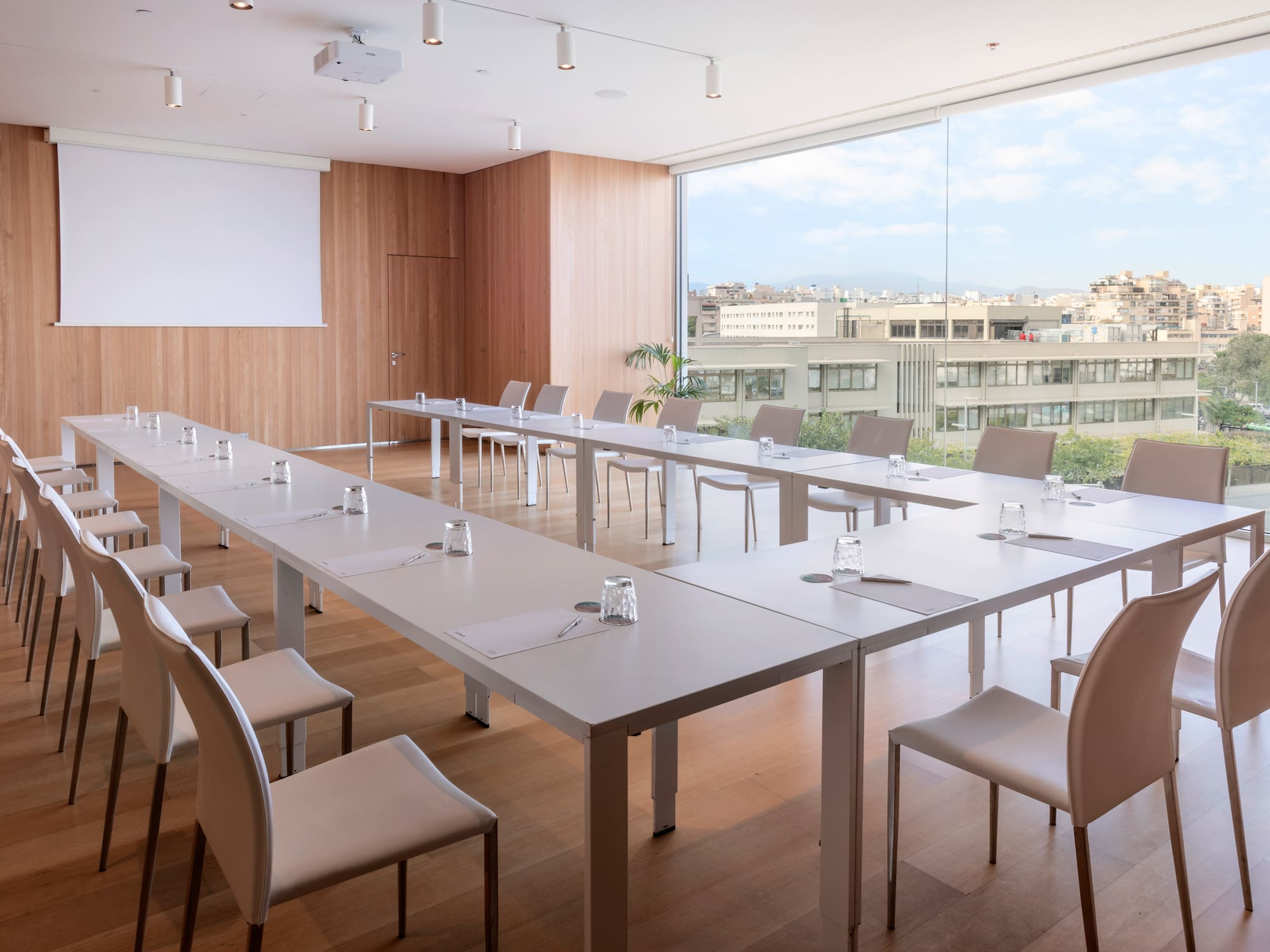 a room with white tables and chairs