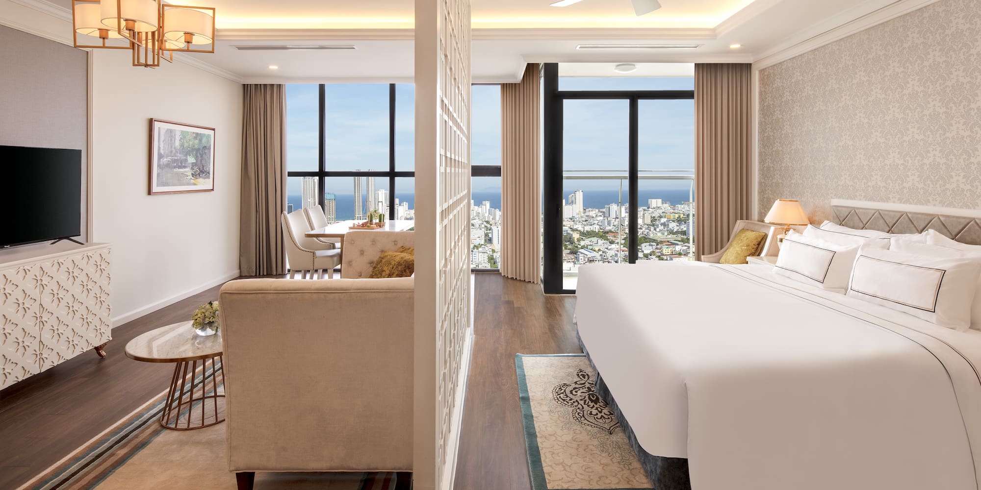 a room with a large bed and a couch and a table