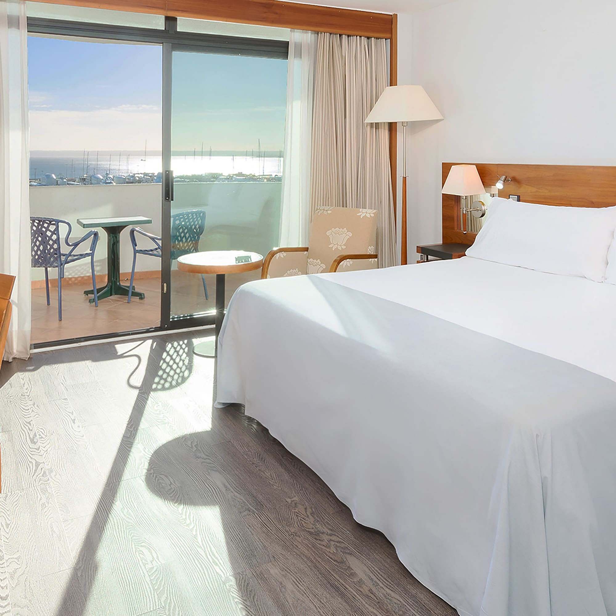 a room with a bed and a table and chairs