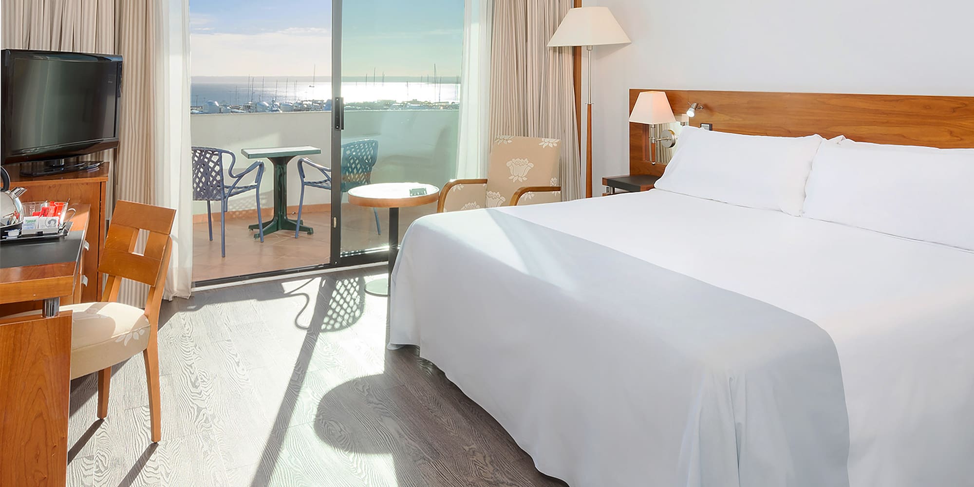 a room with a bed and a table and chairs