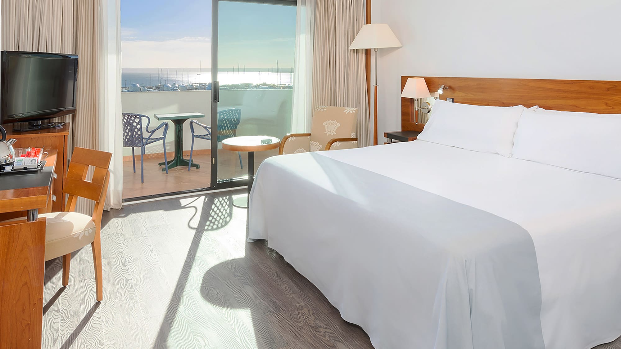 a room with a bed and a table and chairs