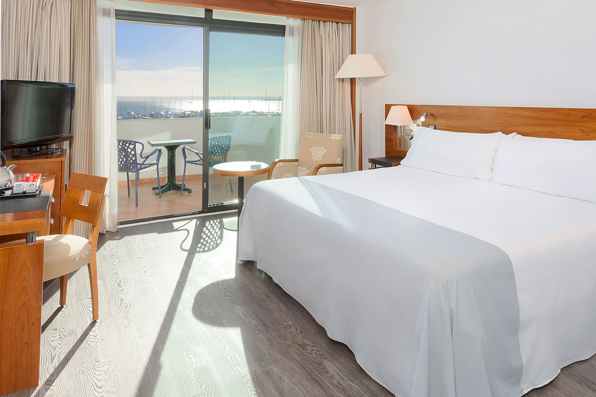 a room with a bed and a table and chairs