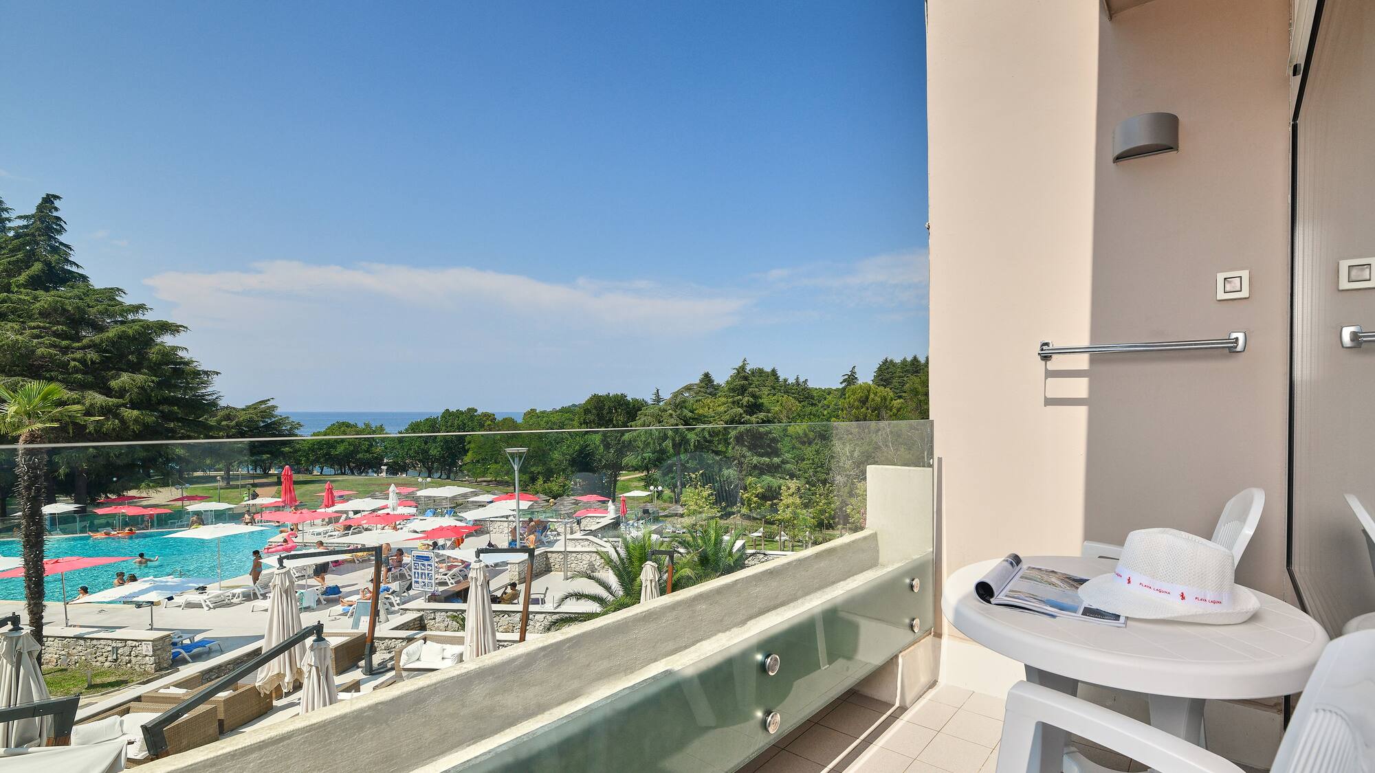 a balcony with a view of a pool and a table