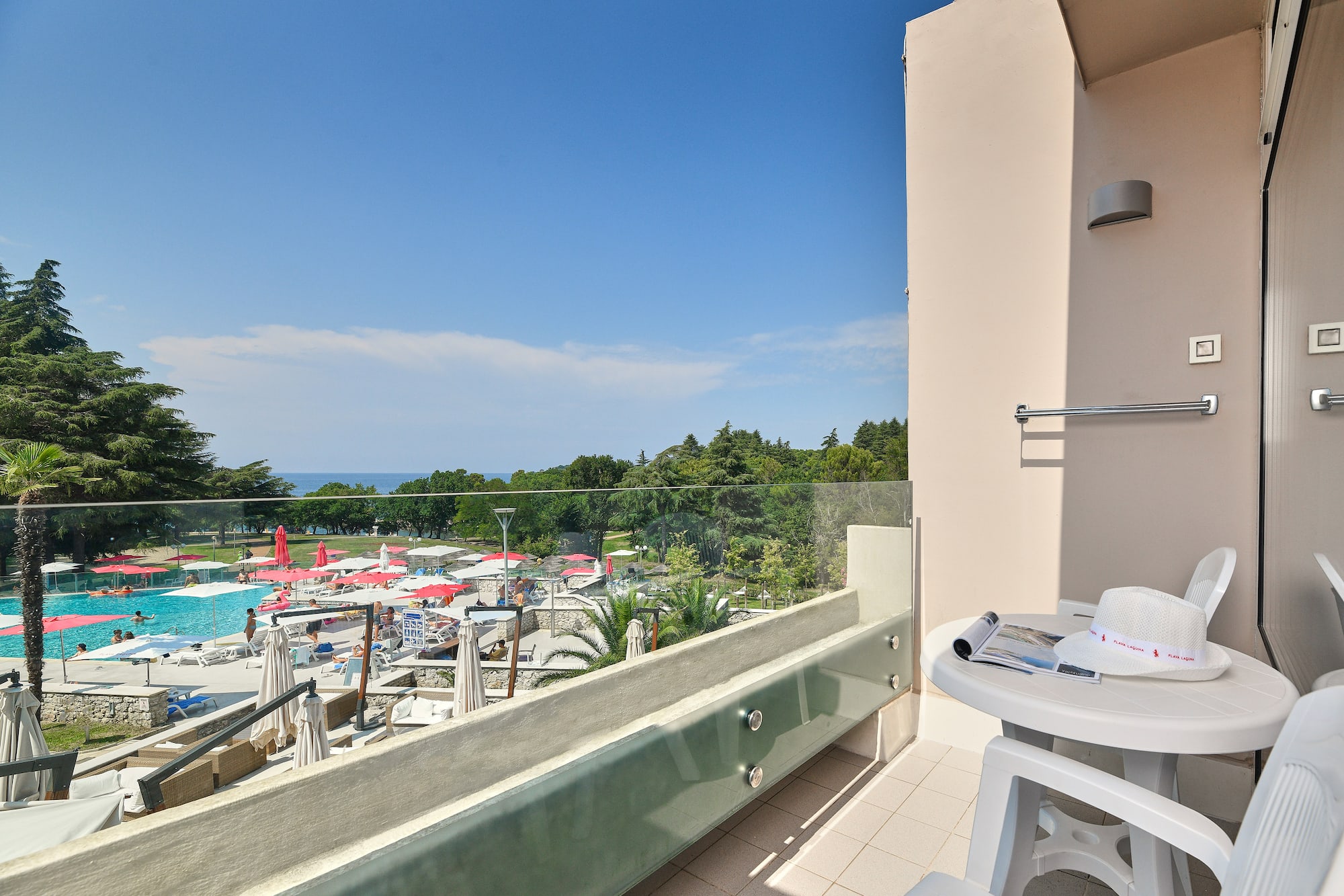 a balcony with a view of a pool and a table