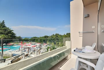 a balcony with a view of a pool and a table