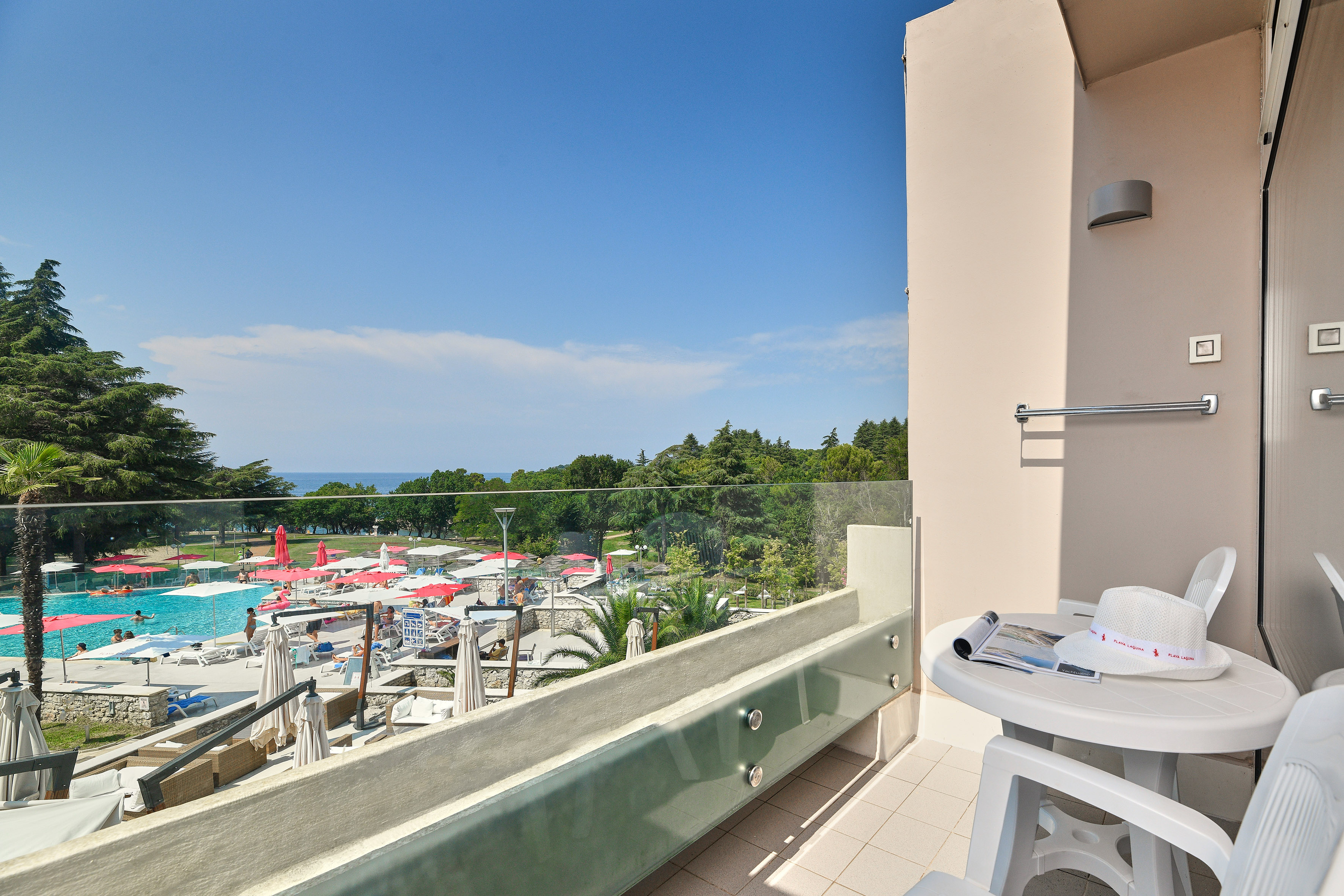 a balcony with a view of a pool and a table