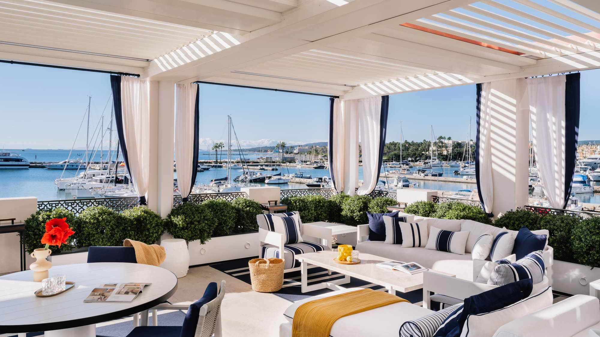 a white and blue outdoor patio with a table and chairs