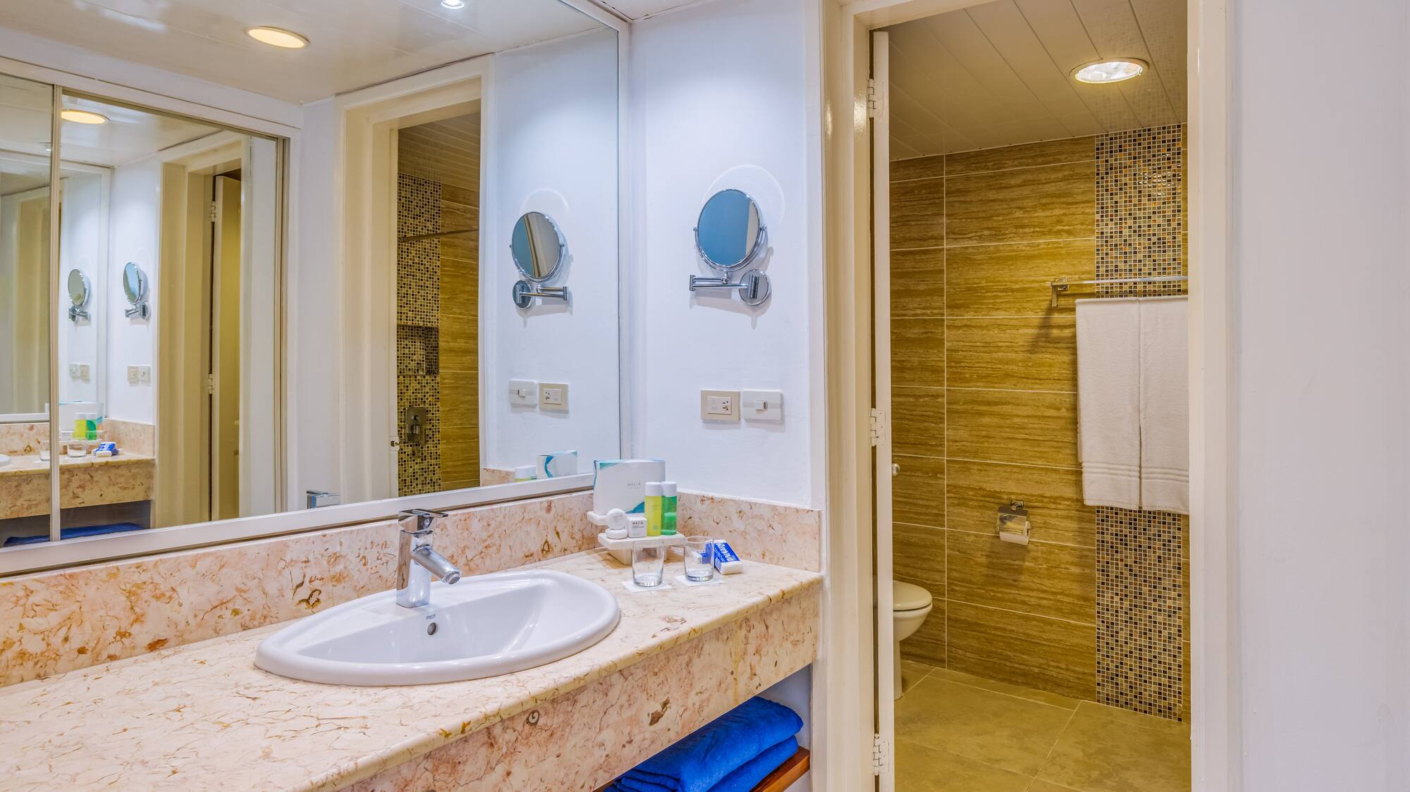 a bathroom with a marble countertop and a shower