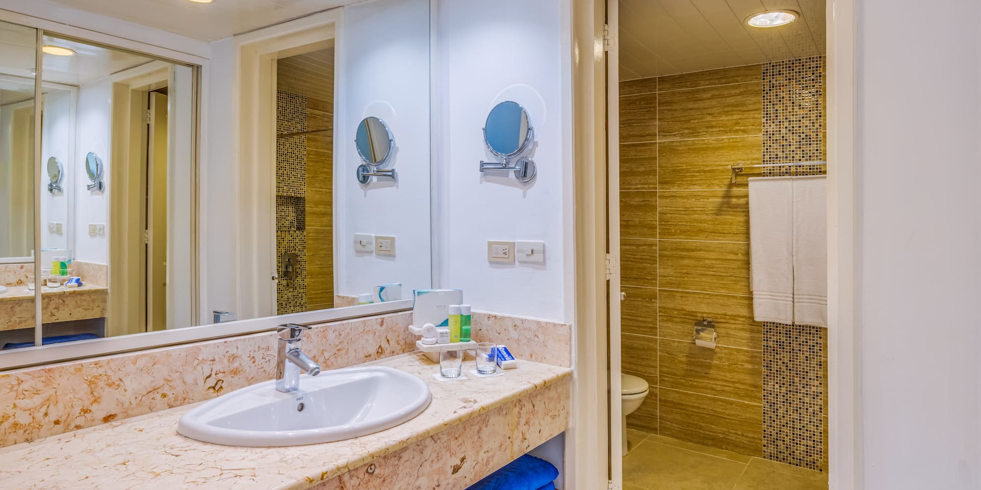 a bathroom with a marble countertop and a shower