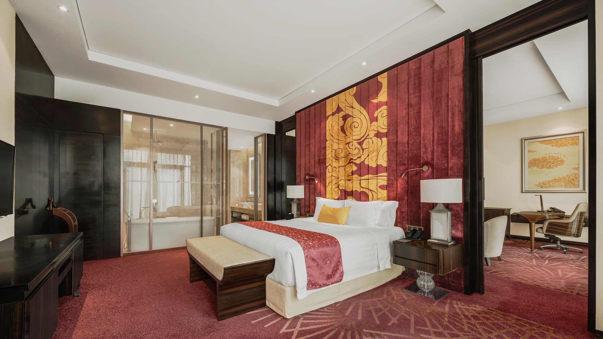 a room with a bed and red carpet