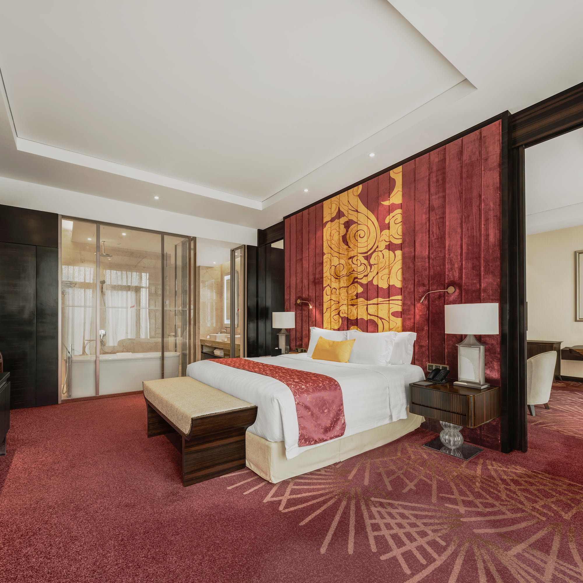 a room with a bed and red carpet