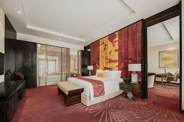 a room with a bed and red carpet