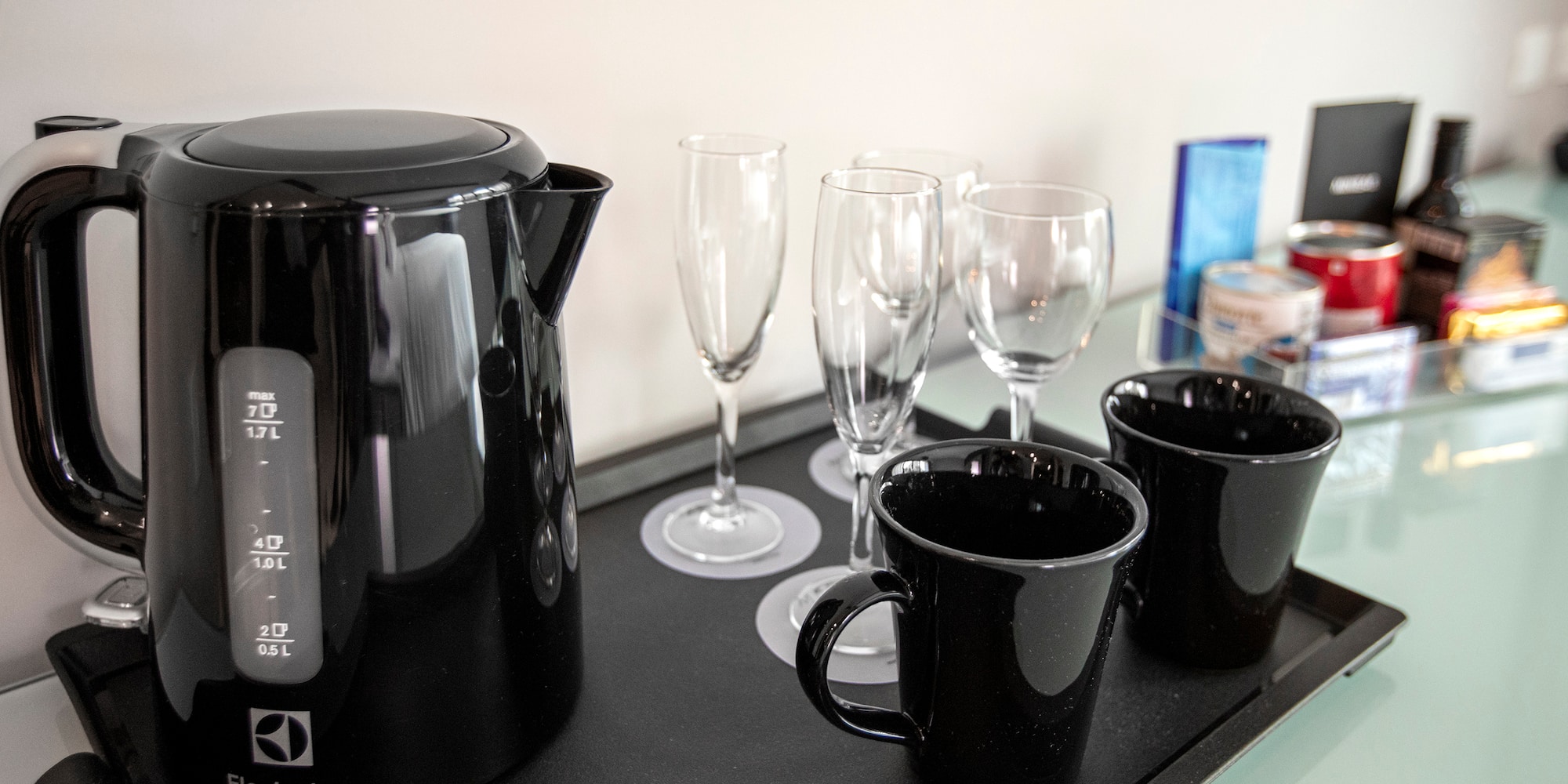 a black kettle and cups on a black tray