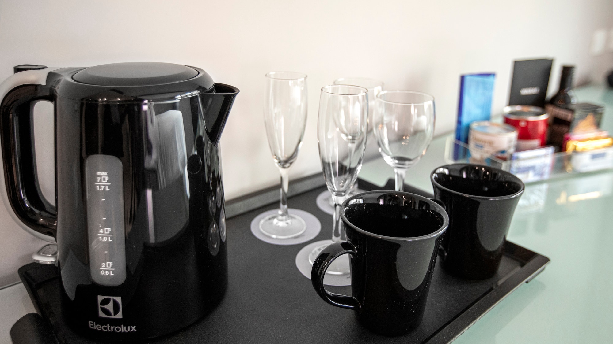 a black kettle and cups on a black tray
