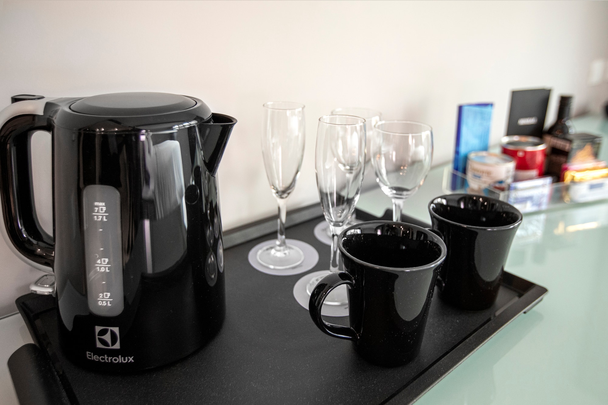 a black kettle and cups on a black tray