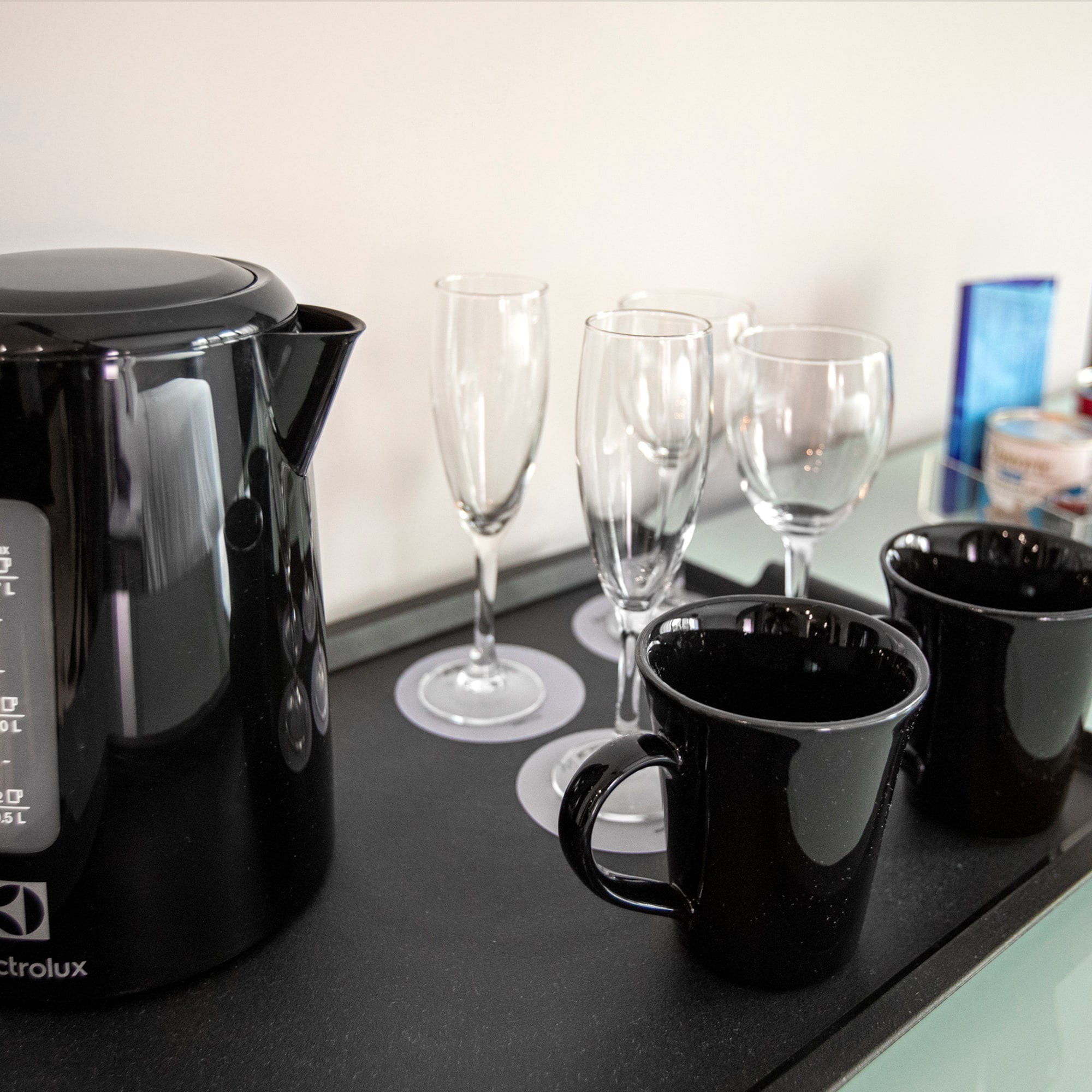 a black kettle and cups on a black tray
