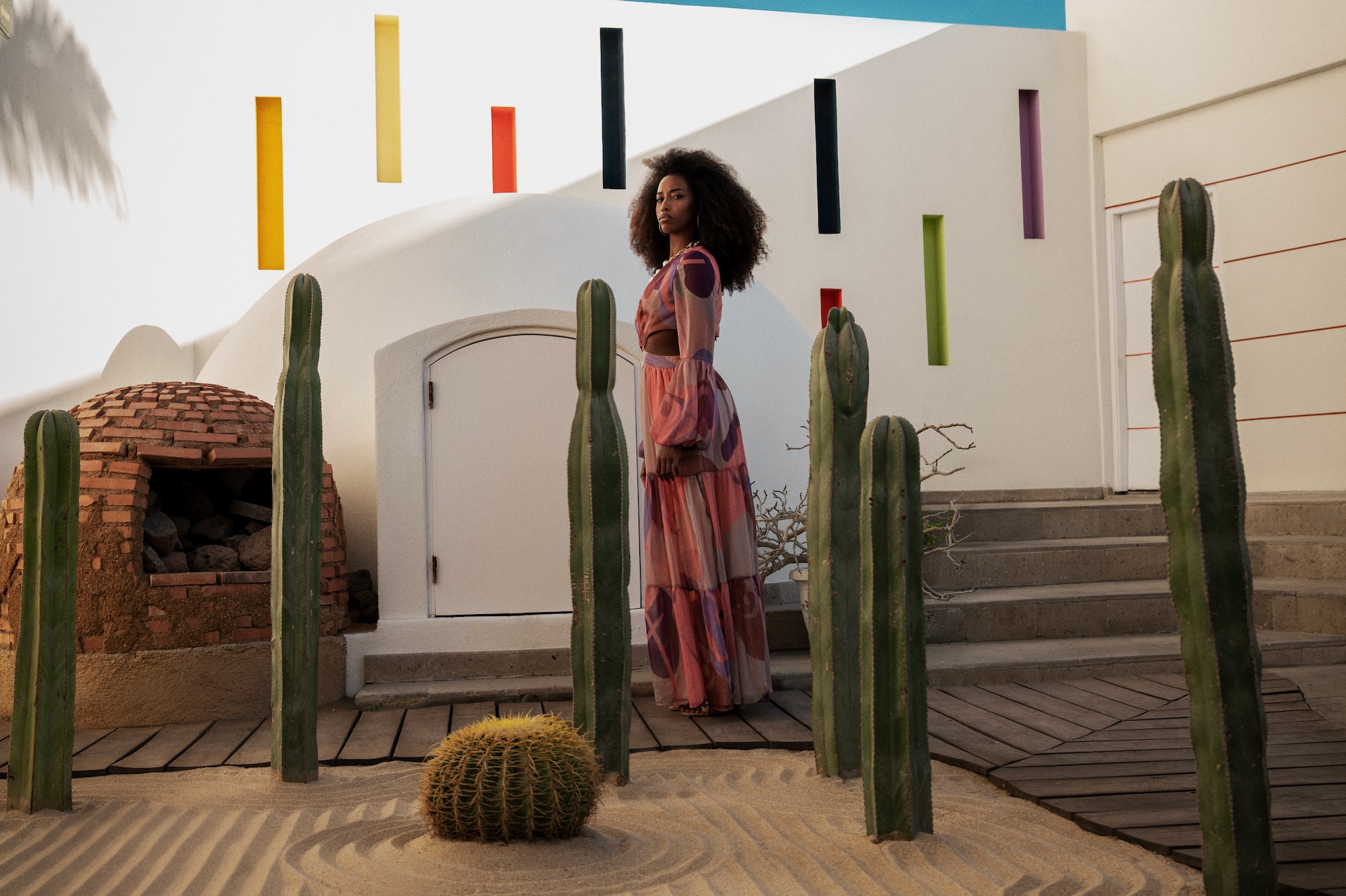 a woman standing in a desert garden
