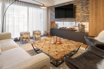 a living room with a fireplace and a tv