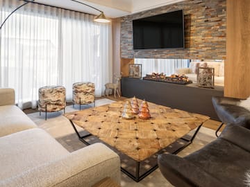 a living room with a fireplace and a tv