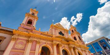a pink building with a cross on top