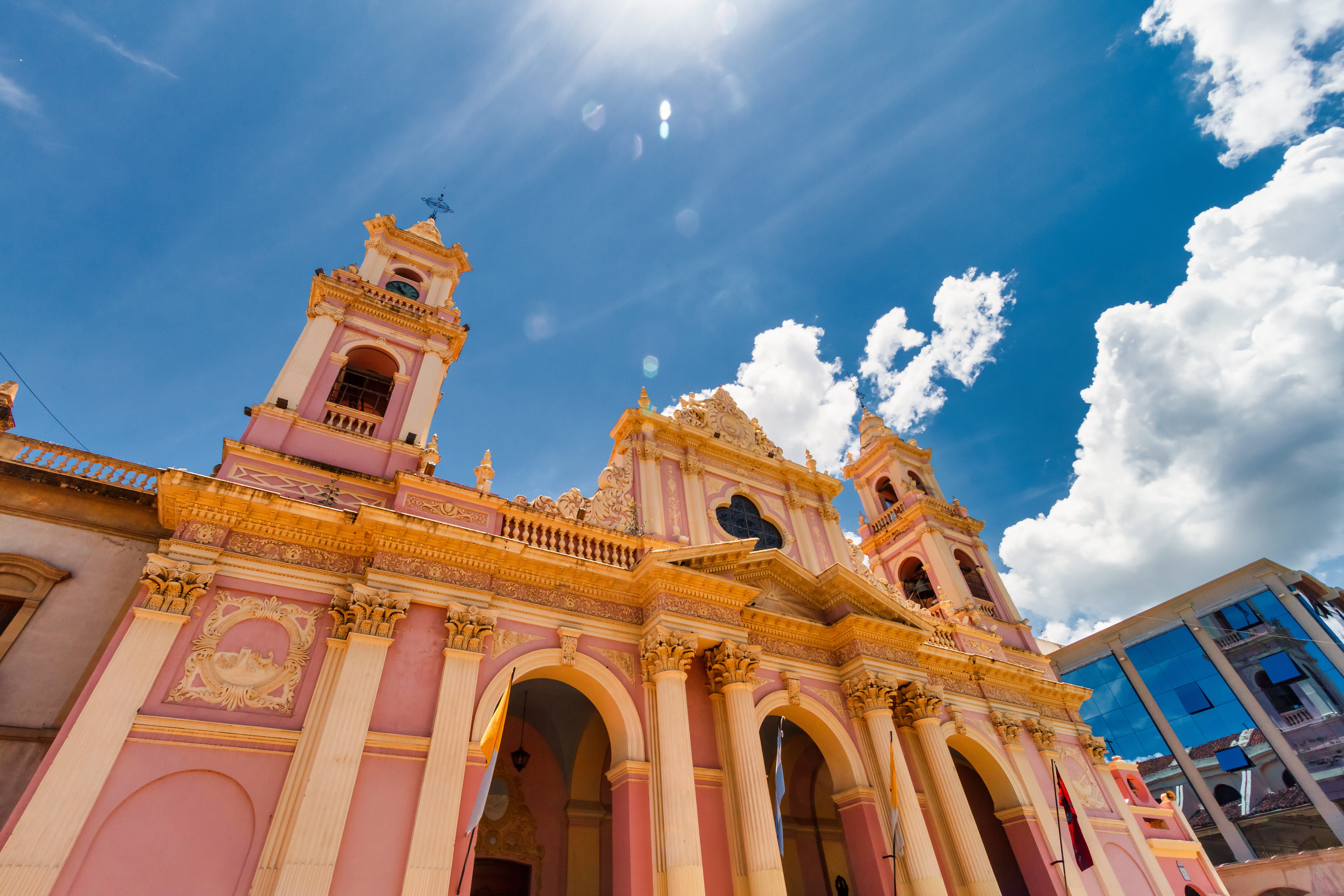 a pink building with a cross on top