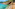 a beach with a rocky cliff and trees