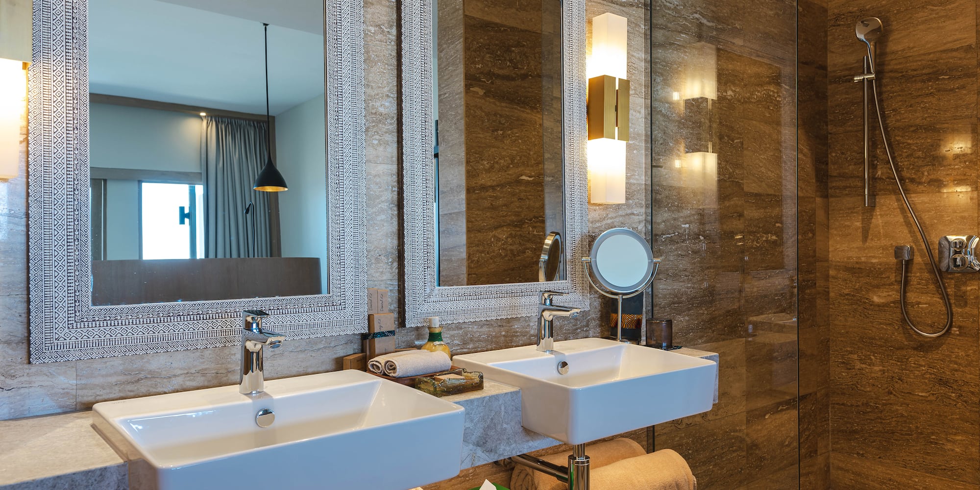 a bathroom with two sinks and a shower