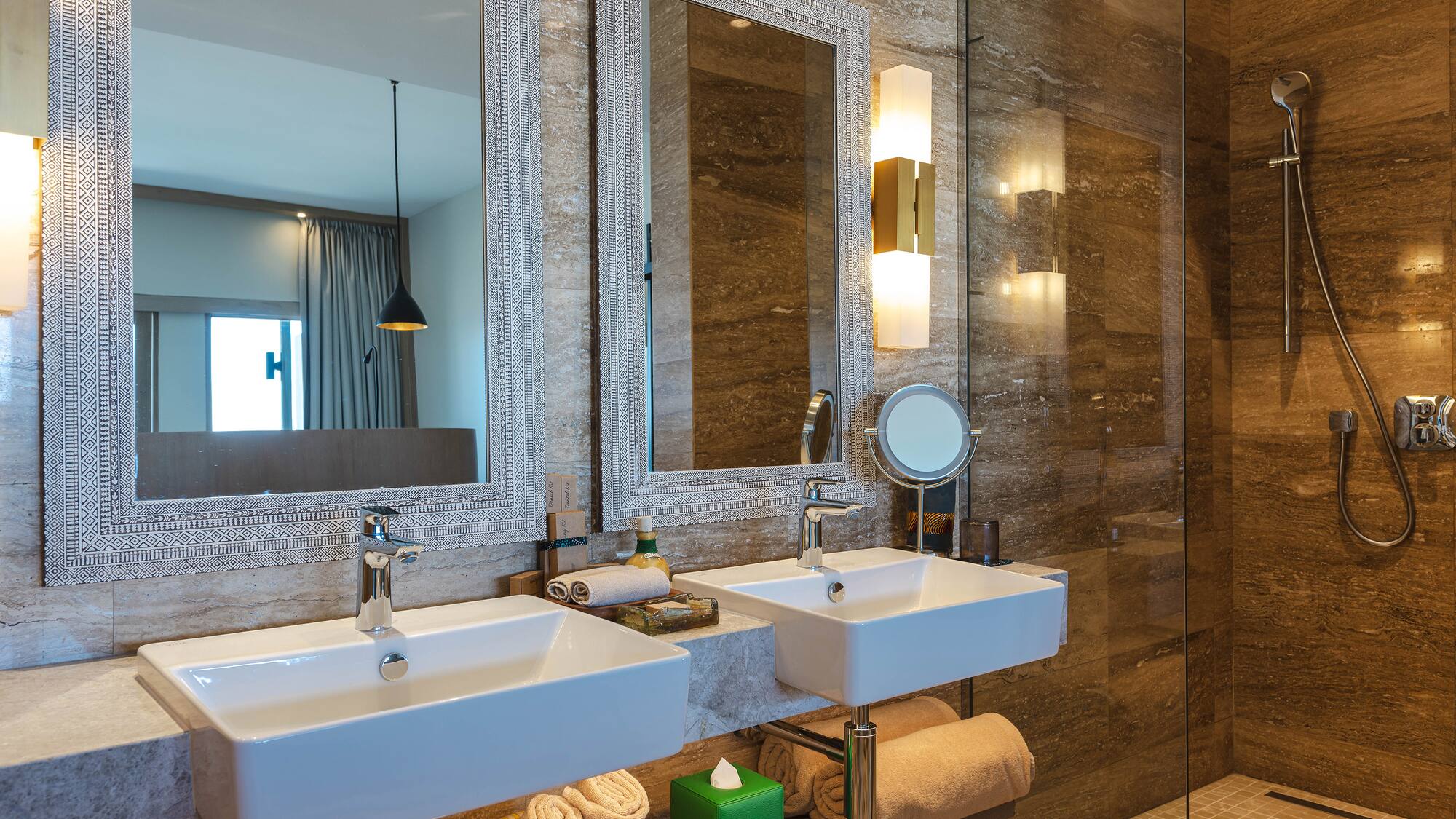 a bathroom with two sinks and a shower