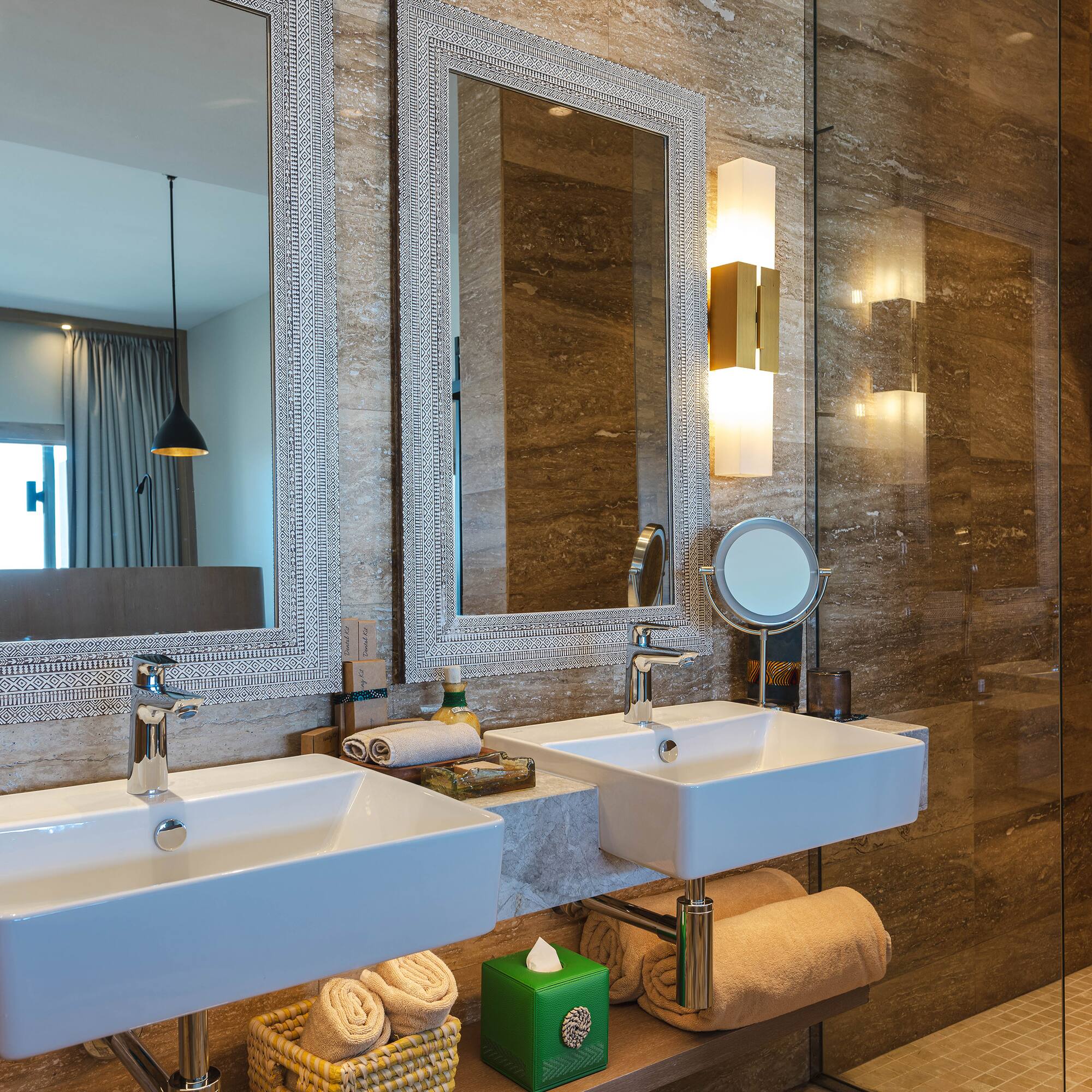 a bathroom with two sinks and a shower