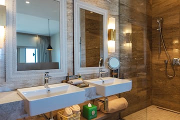 a bathroom with two sinks and a shower