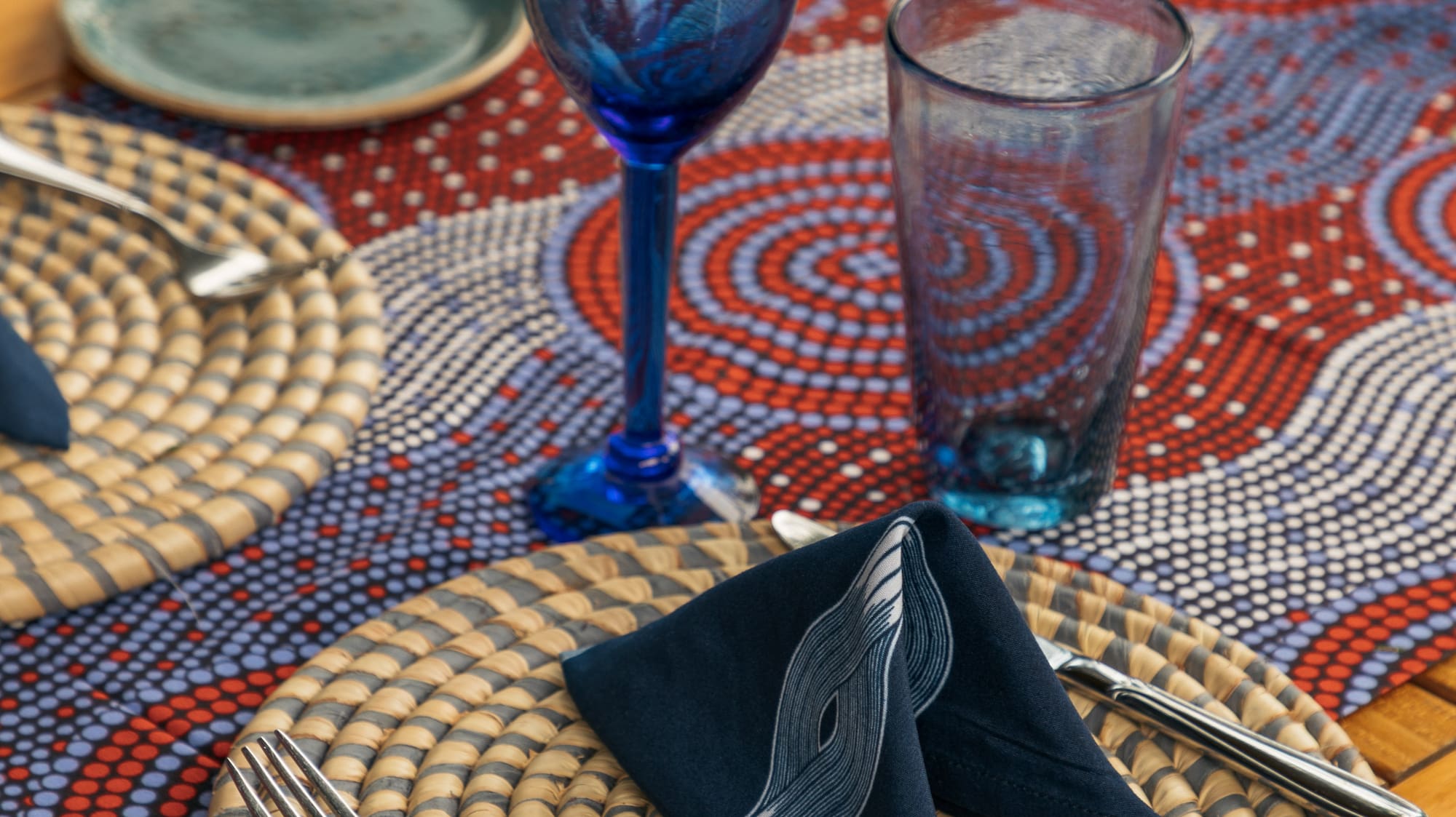 a table with a blue napkin and glasses
