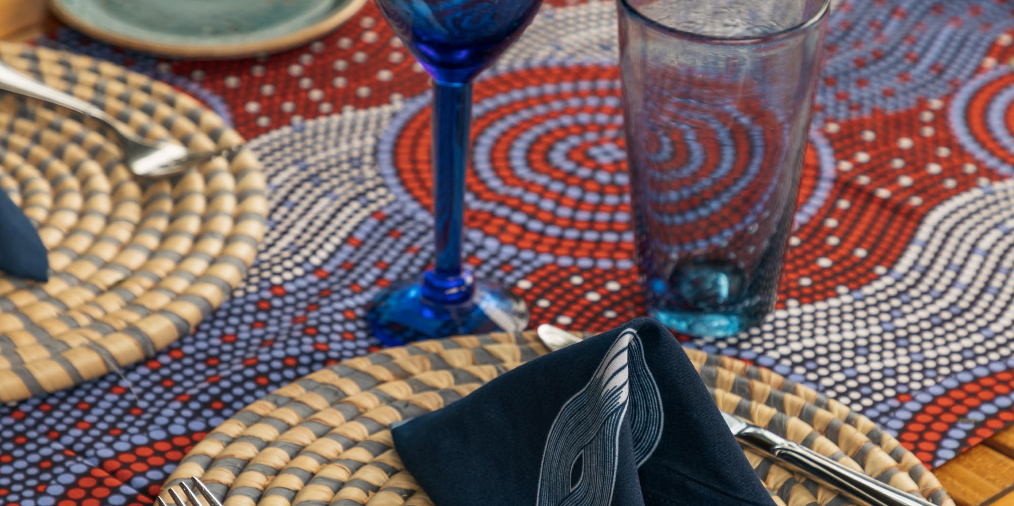 a table with a blue napkin and glasses