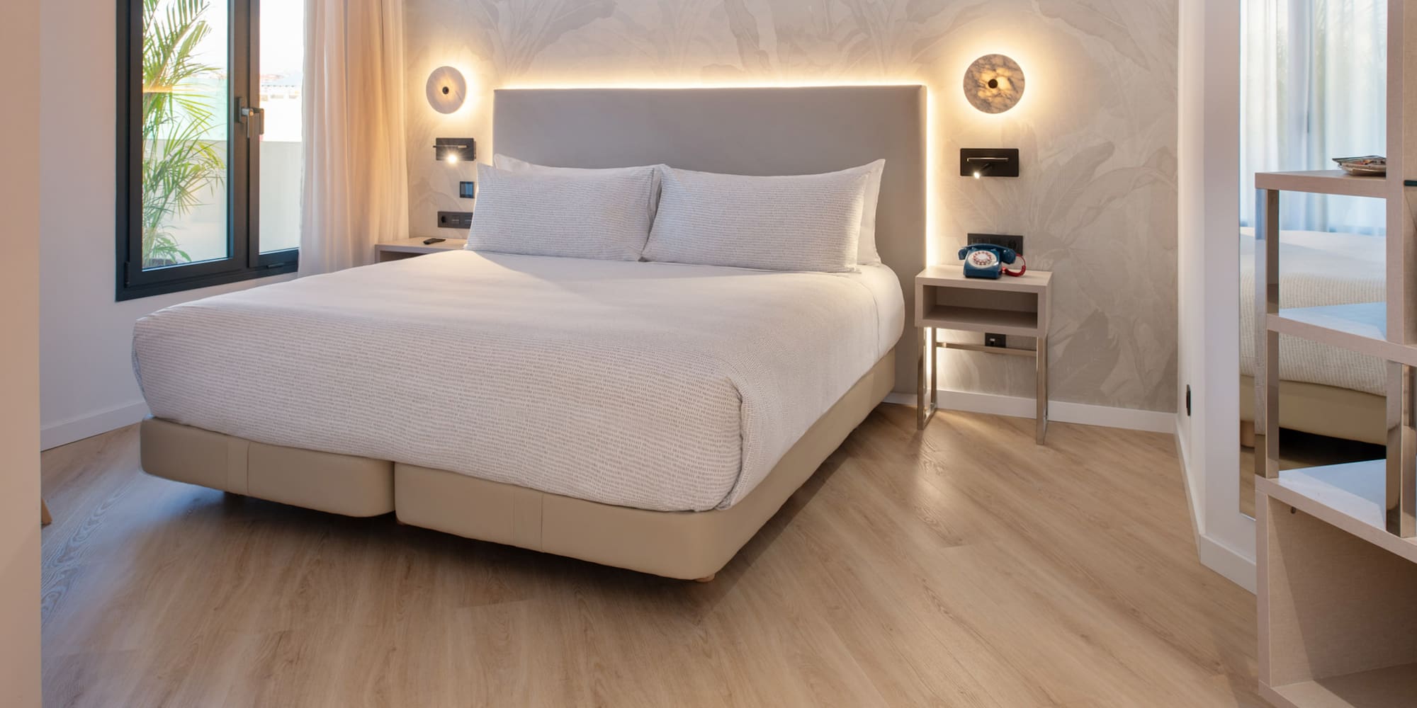 a bed with a light on the wall