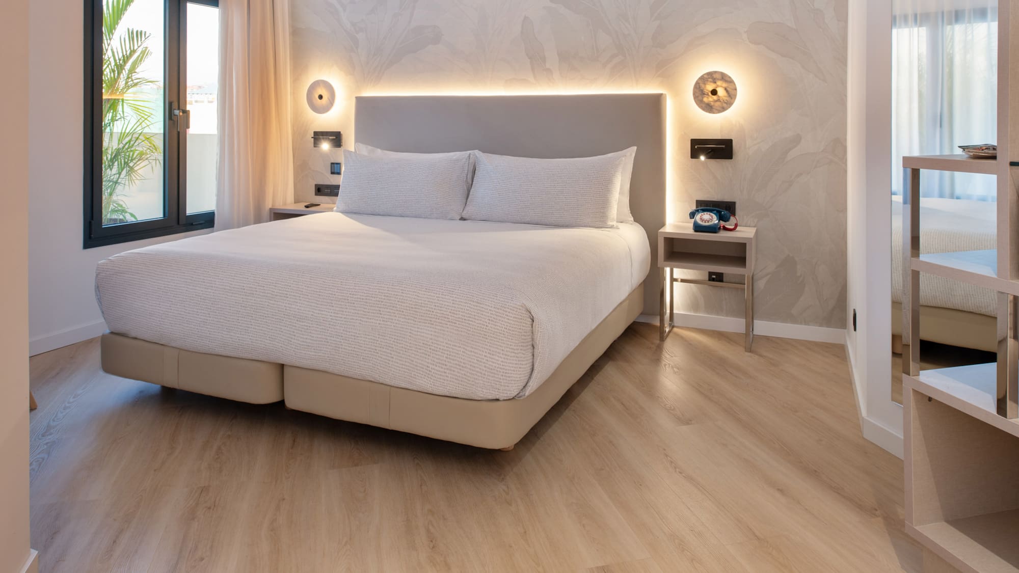 a bed with a light on the wall