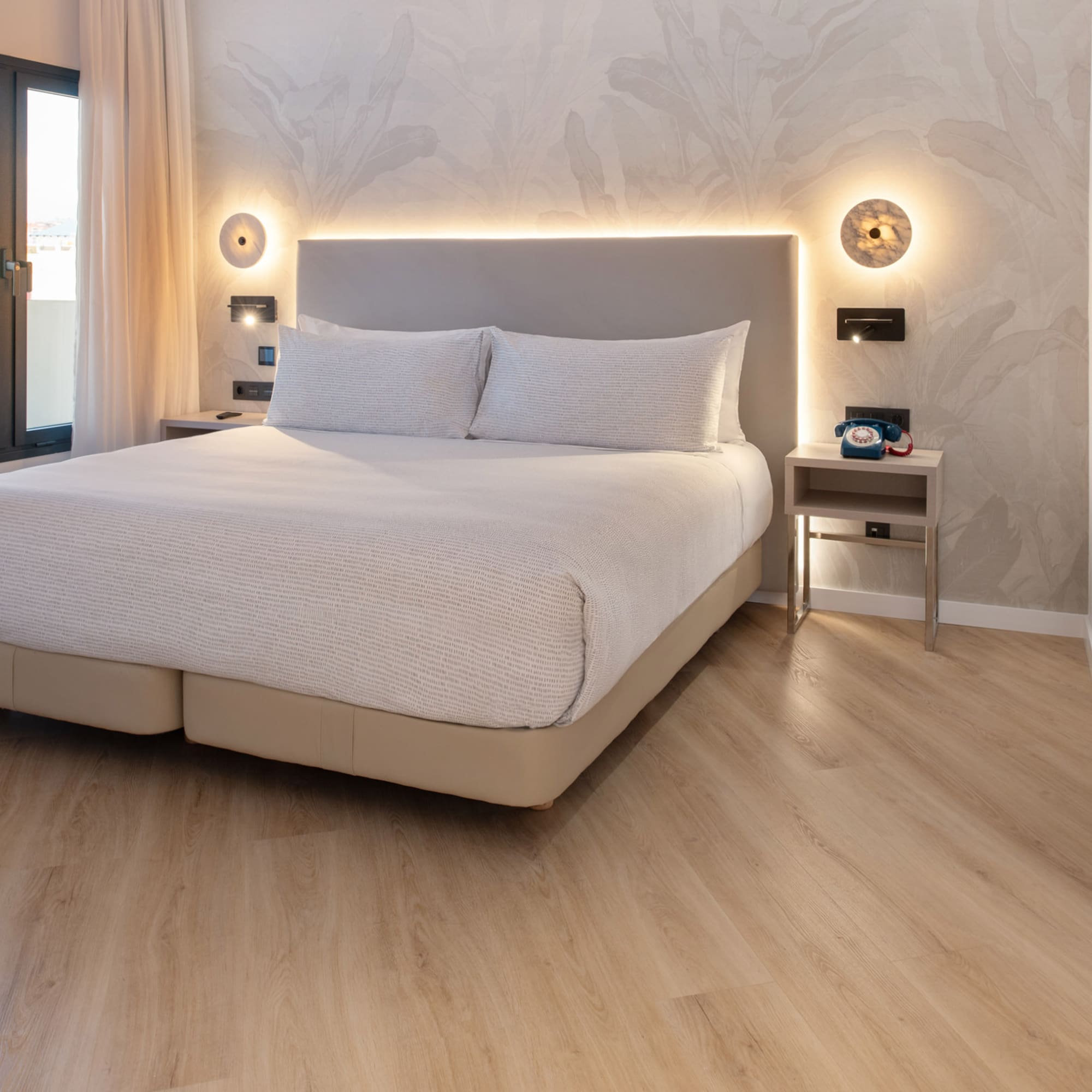 a bed with a light on the wall